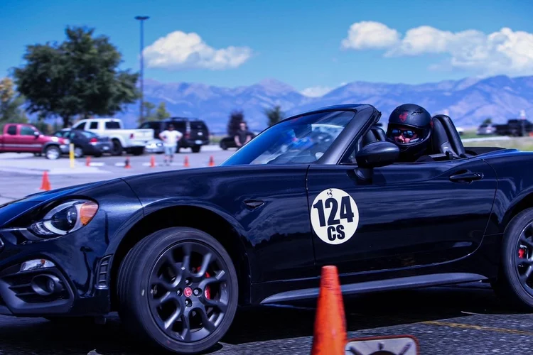 Aaron driving his black Fiat 124 Spider Abarth at an SCCA autocross