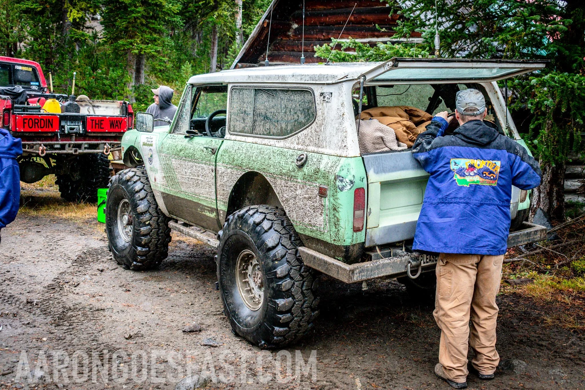 Green International Scout with its rear hatch open on the McElvy Lake trail in the Tobacco Roots