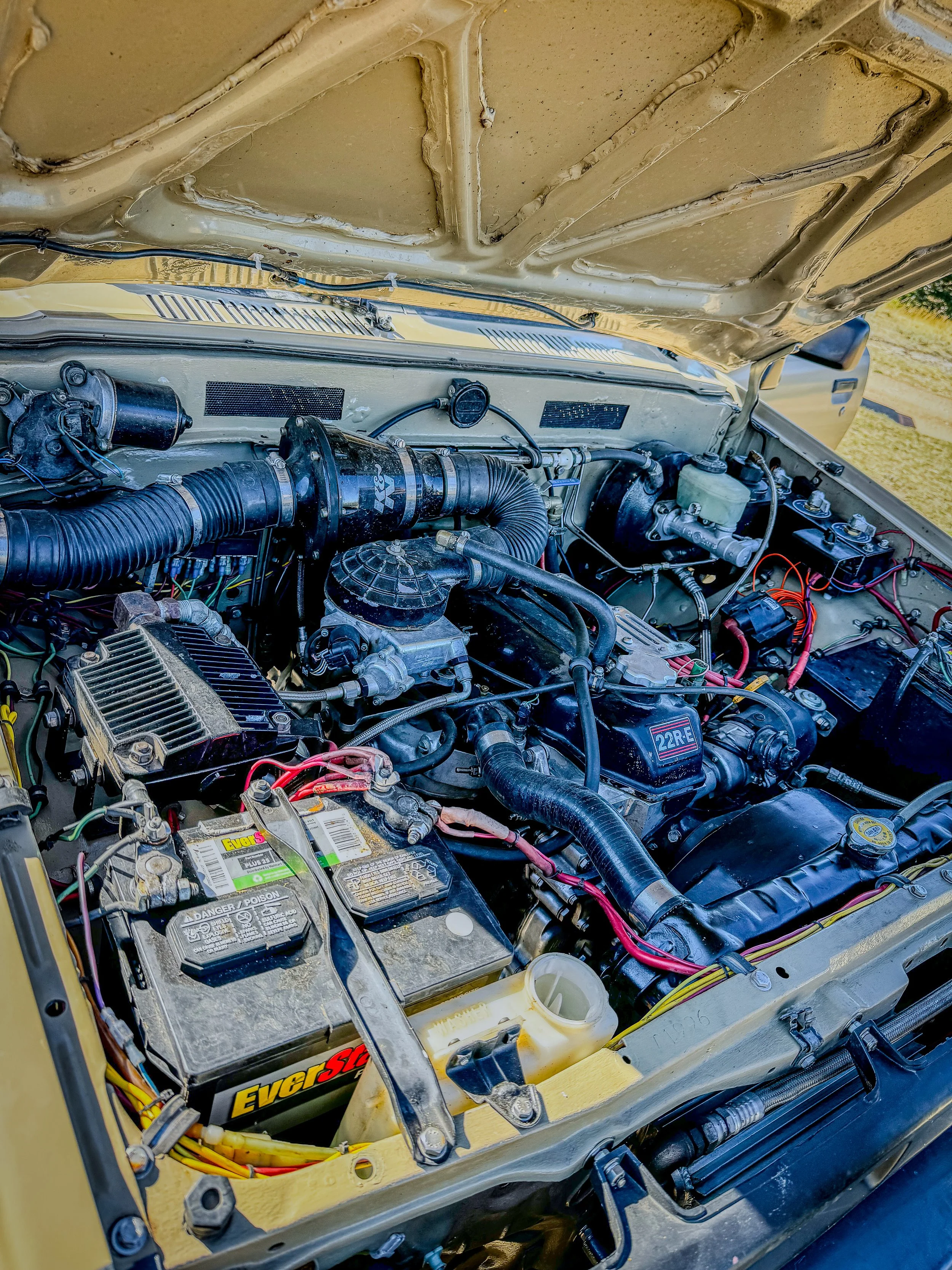 Engine bay of a tan Toyota truck at Revenue Flats