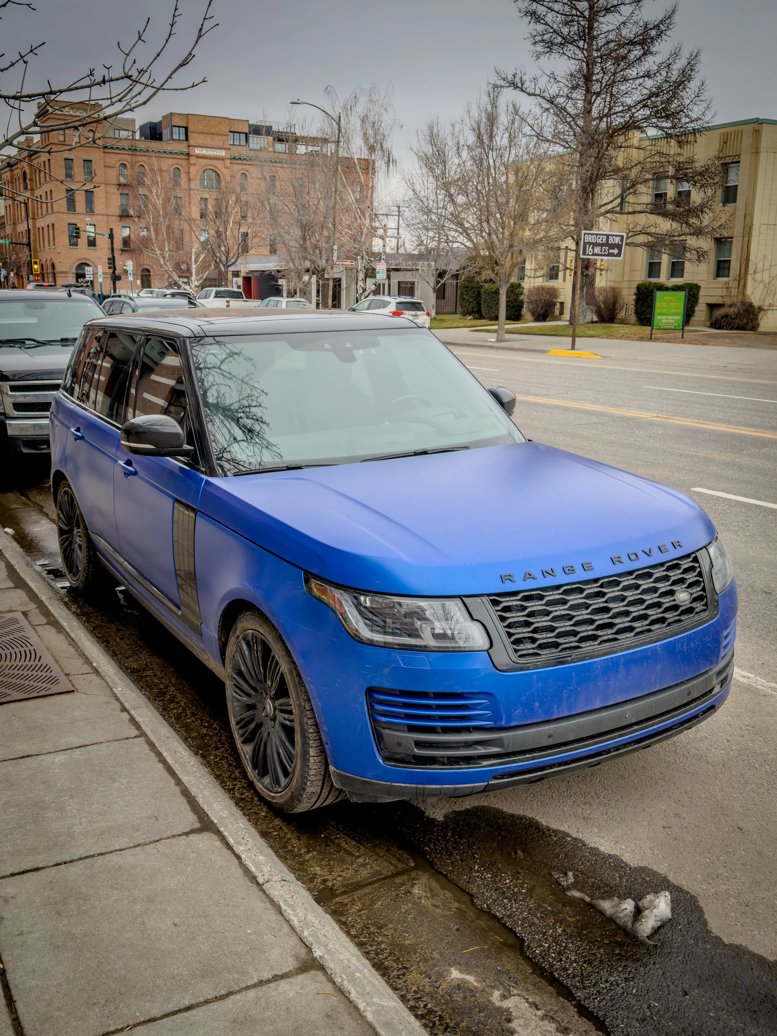 Blue Range Rover parked on a city street