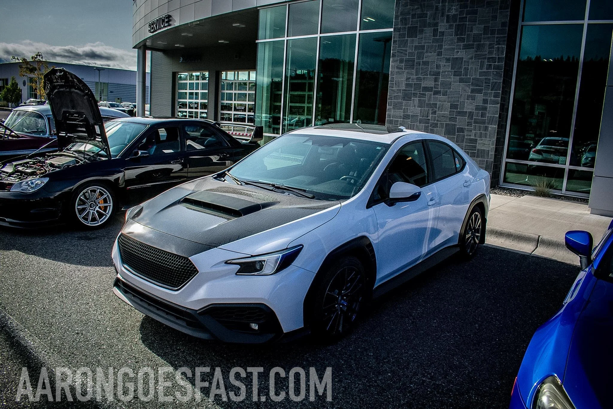 White Subaru WRX with a black hood at Ressler Cars & Coffee