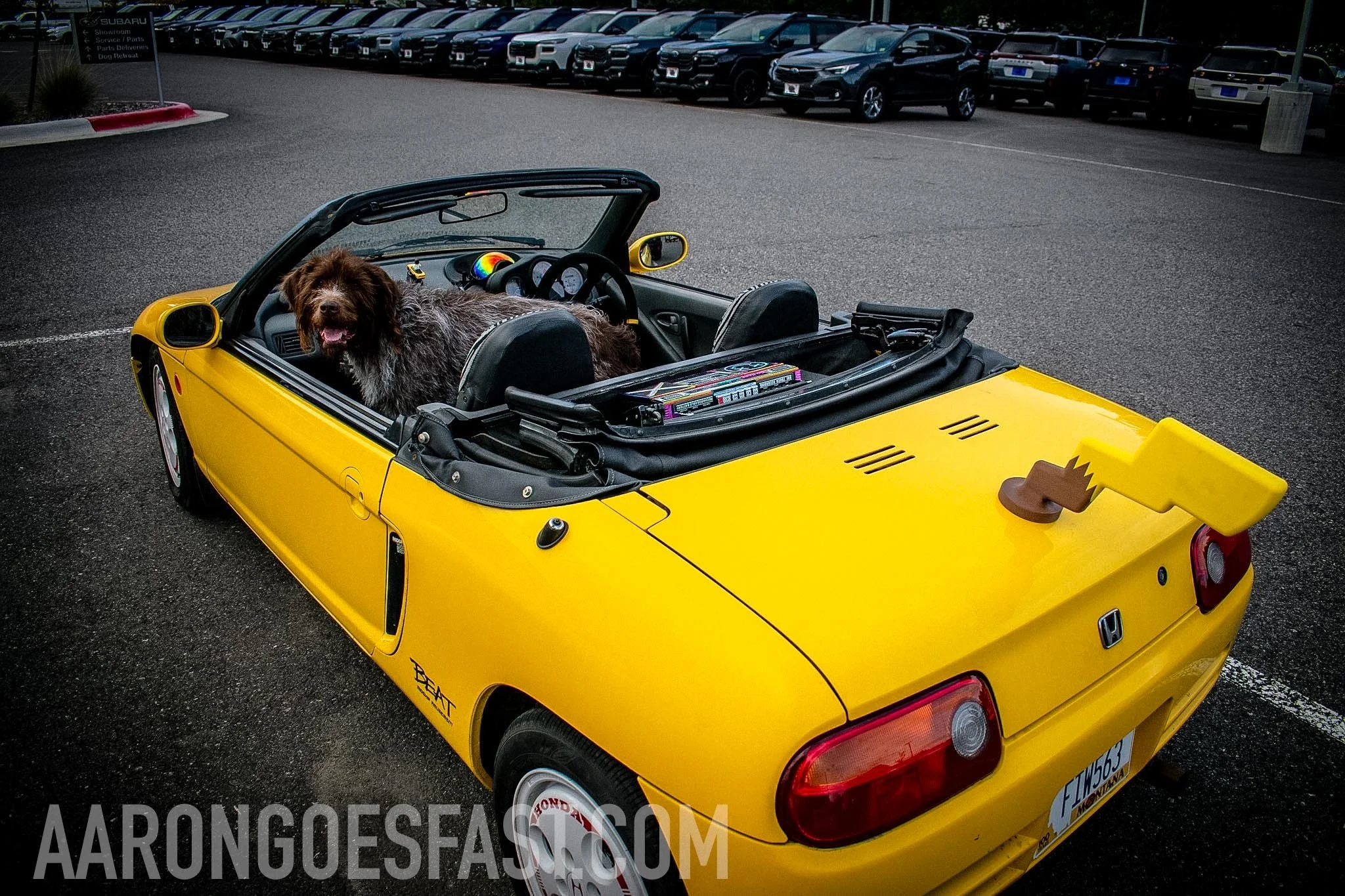 Yellow Honda Beat with the top down, rear view at Ressler Cars & Coffee