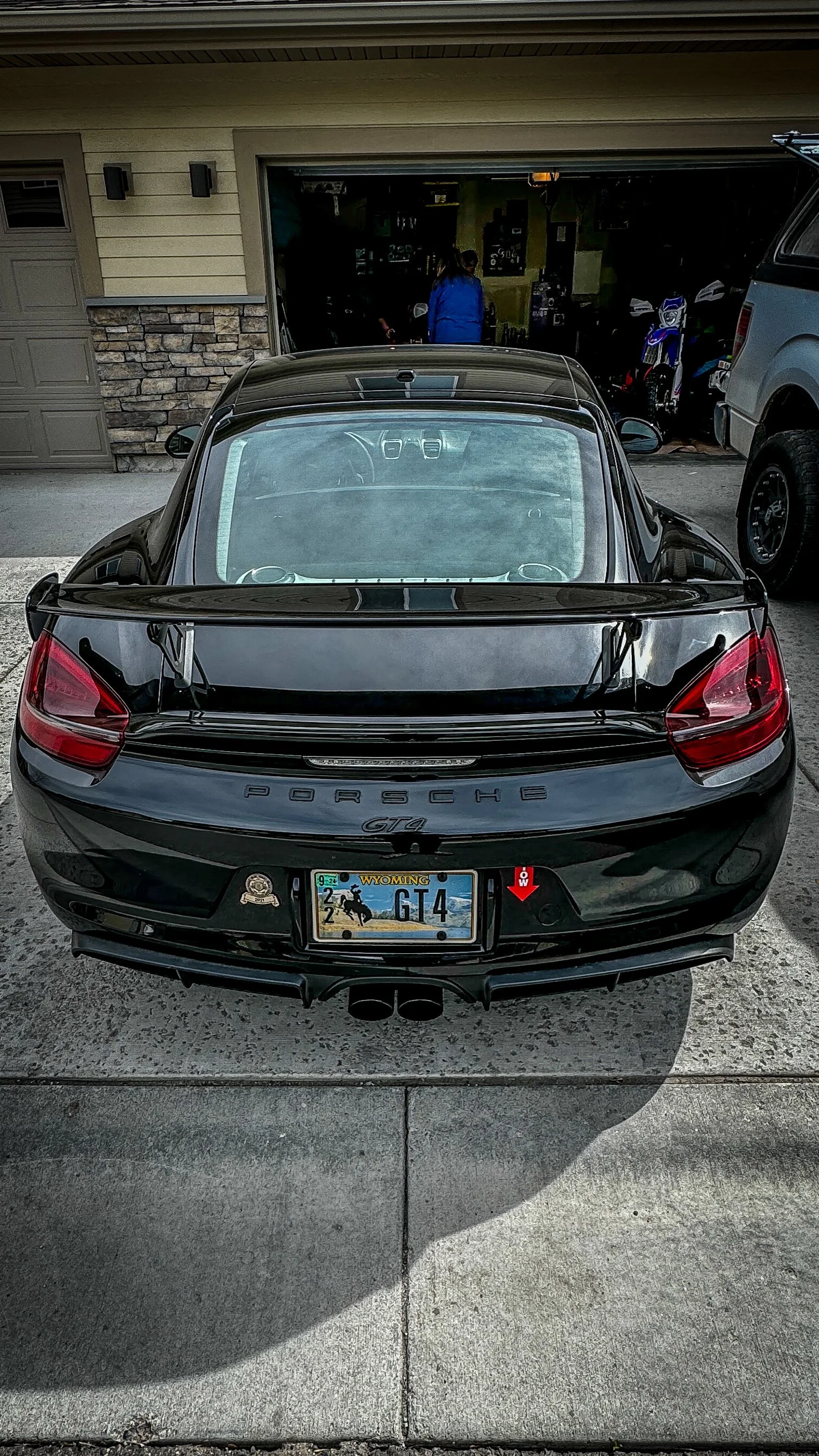Black Porsche GT4, rear view