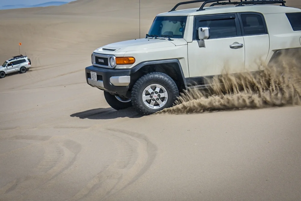 FJ Cruiser throwing sand at the dunes