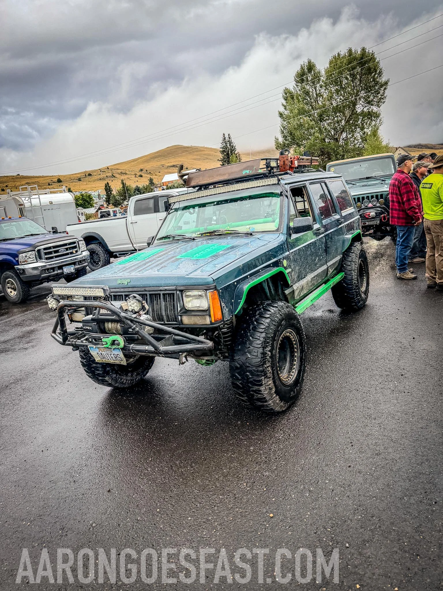 Green Jeep Cherokee XJ in the rain on the McElvy Lake trail in the Tobacco Roots