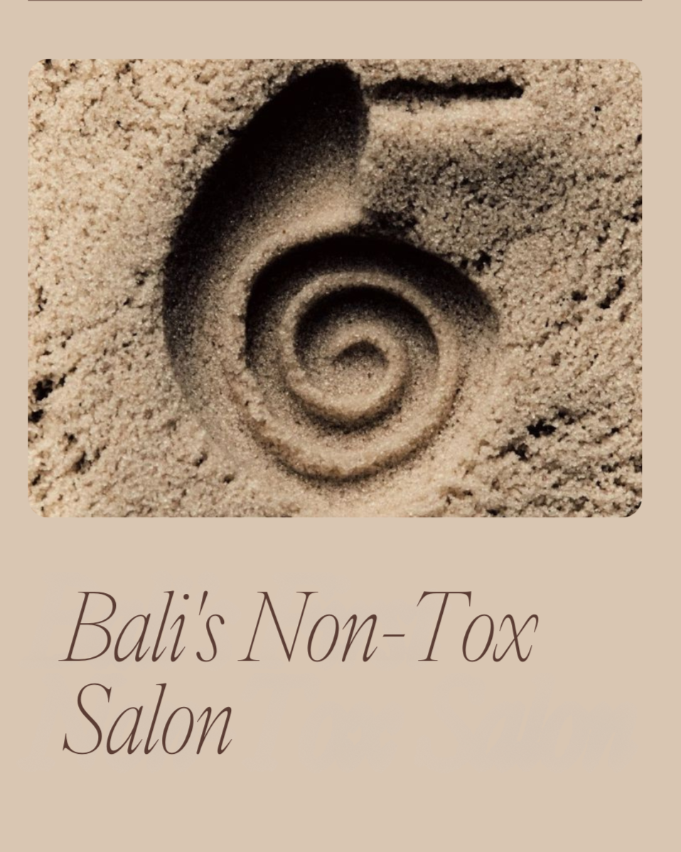 Close-up of a sand spiral pattern with the text "Bali's Non-Tox Salon" beneath it.