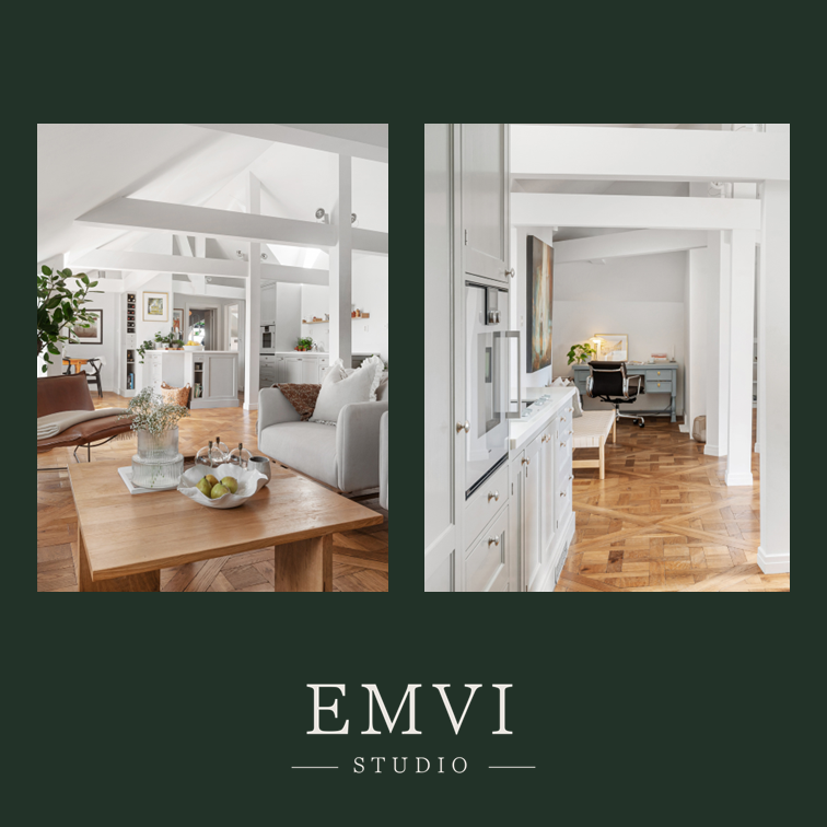 Bright, modern living room with white walls, wooden flooring, and a mix of white and brown furniture, including a sofa, coffee table with a bowl of fruits, and various decorative plants.