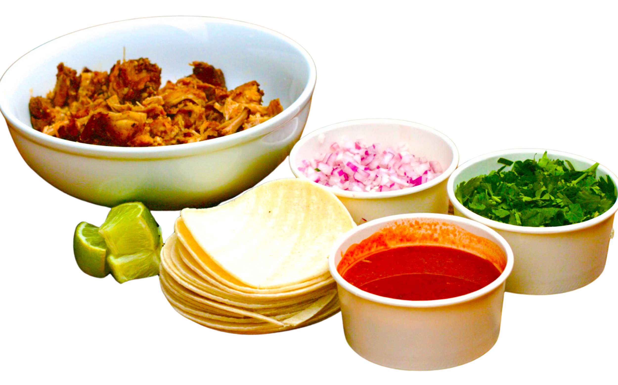 A bowl of shredded meat, chopped onions, cilantro, salsa, sliced lime, and tortilla chips for making tacos.