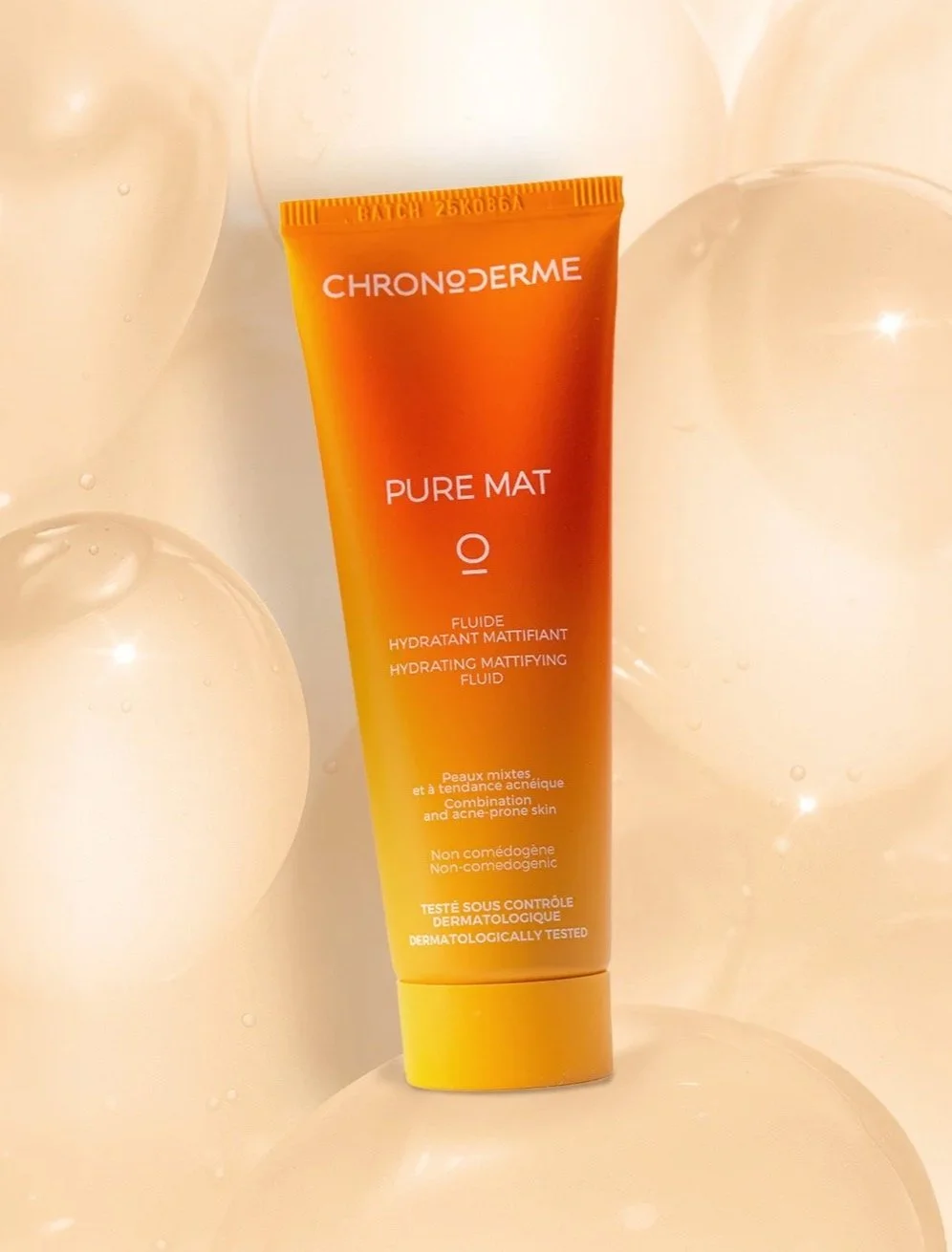 Orange and yellow tube of Chrono Derma Pure Mat Hydrating Matifying Fluid surrounded by clear balloons.