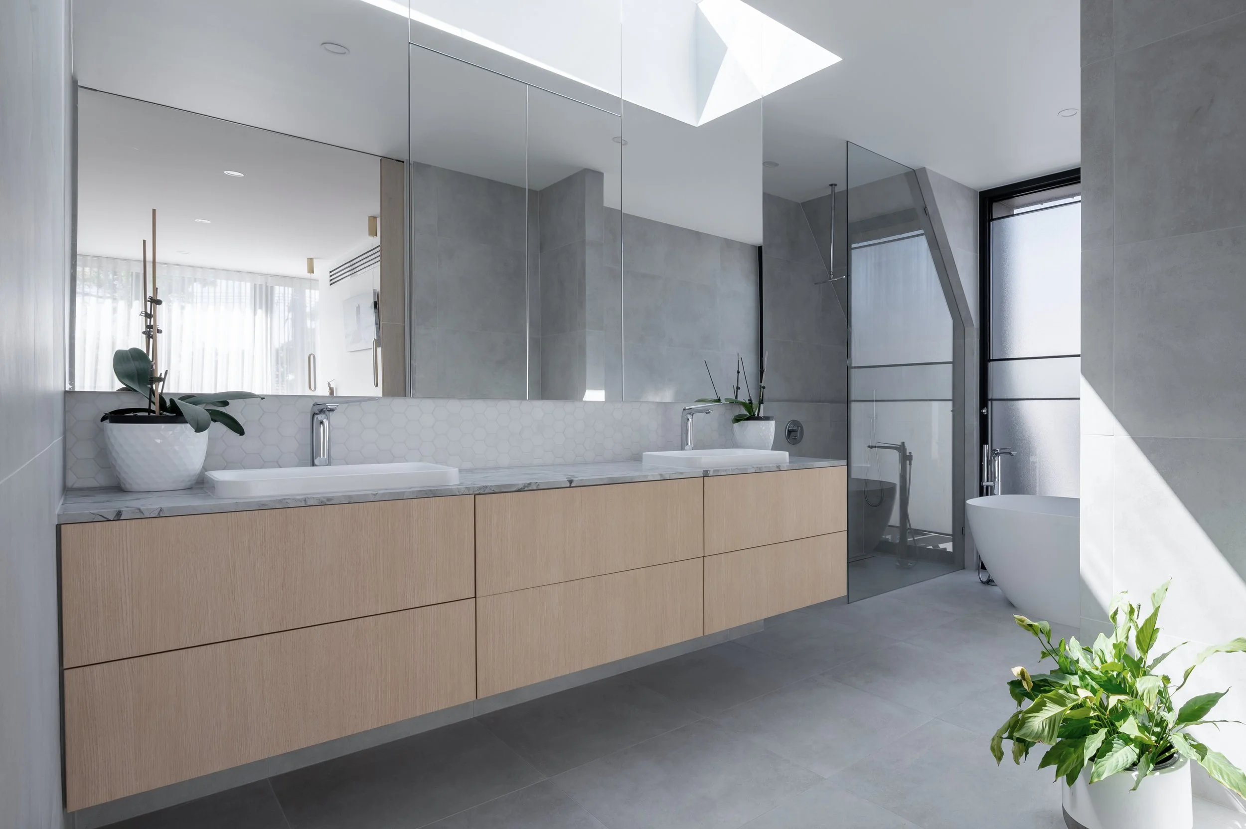 Brighton Project ensuite bathroom featuring an infinity skylight, natural stone vanity top, and marble mosaic feature tiles.