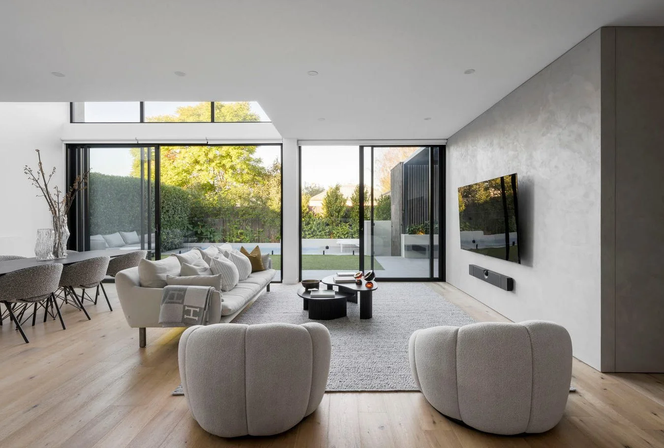 Armadale living room showing the redesigned entertainment wall with TV centred, custom joinery, and furniture arranged for symmetry and improved flow.