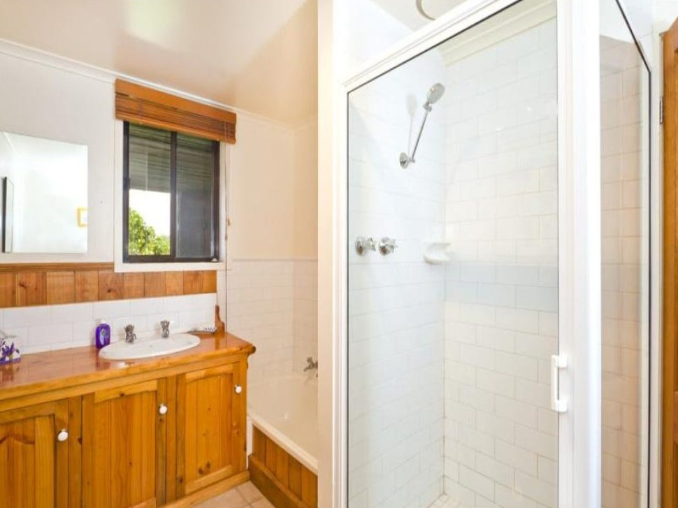 Country Victoria bathroom before renovation, showing cramped layout, outdated fixtures, and limited light.