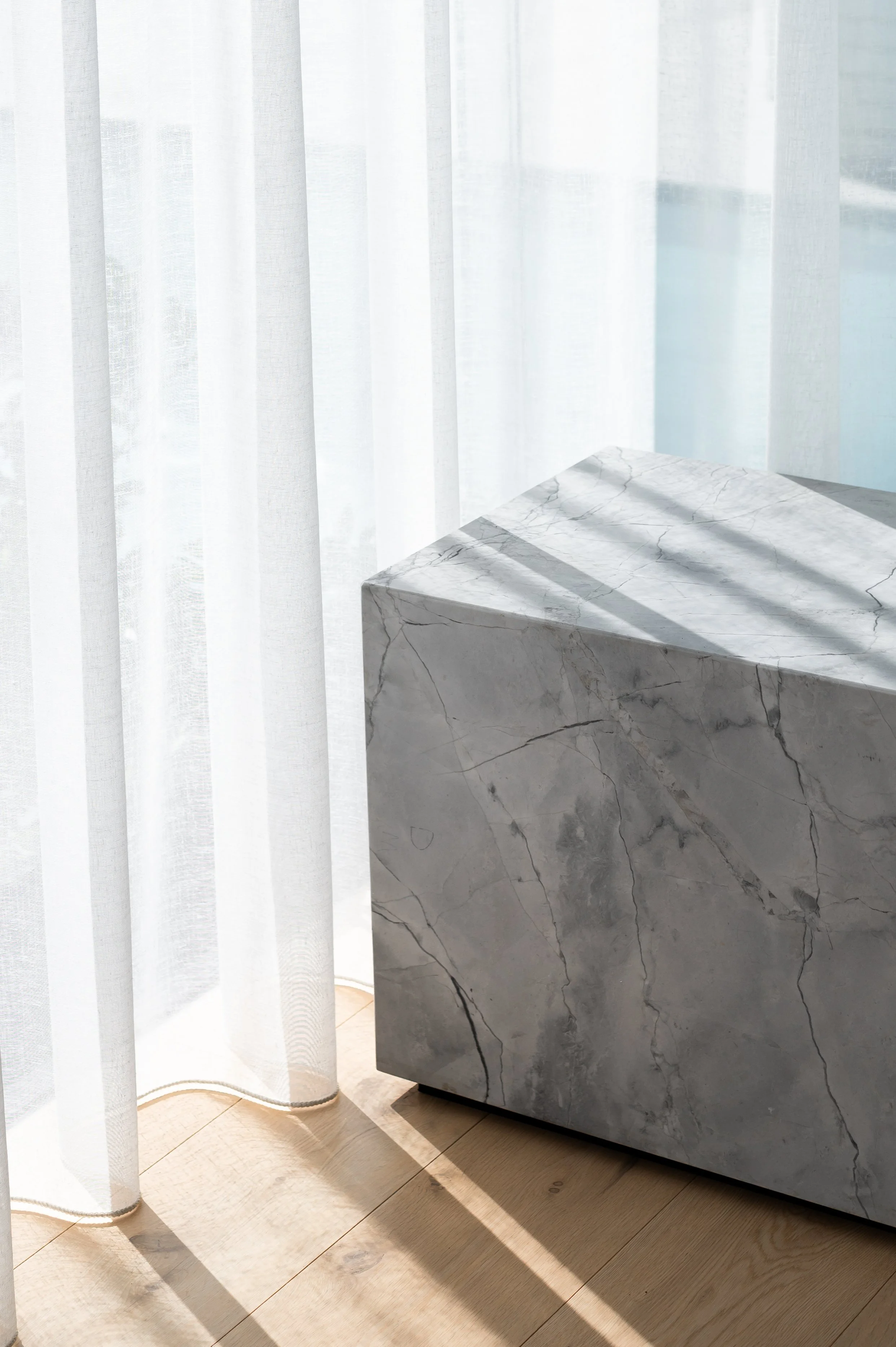 Close-up of the Brighton entertainment unit plinth, detailed to allow the sheer curtain to sit neatly behind it while maintaining a clean, contemporary aesthetic.