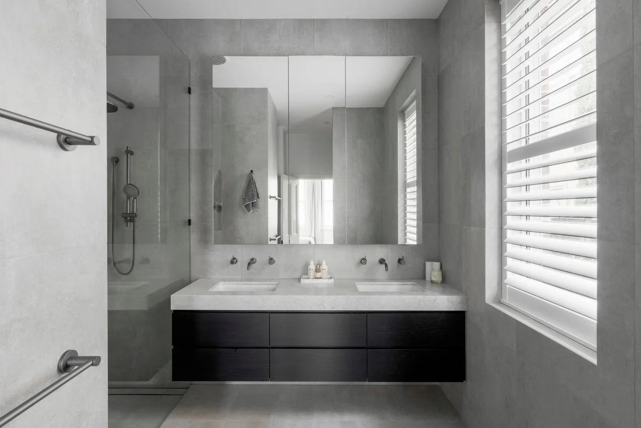 Armadale ensuite bathroom featuring black veneer vanity cabinetry, replacing timber finishes to create a sleek, modern minimalist aesthetic.