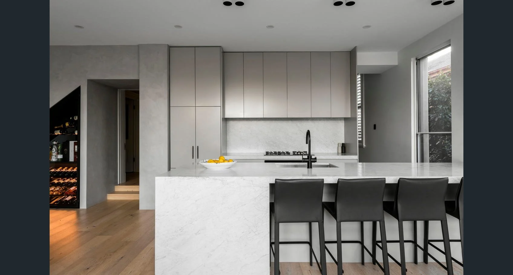 Kitchen in an Armadale residence featuring a cohesive material palette and functional, minimalist design