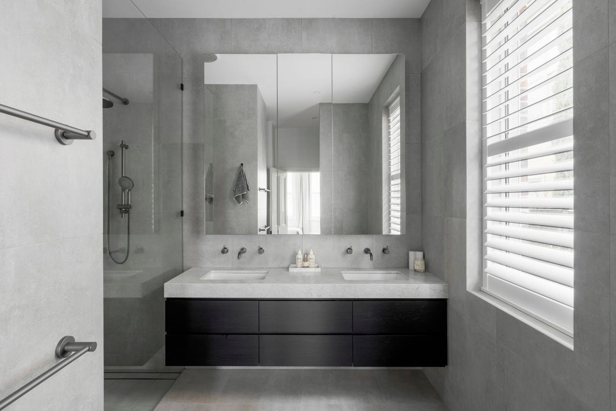 Armadale ensuite bathroom showing vanity changed from golden timber to sleek black veneer, creating a modern, minimalist look.