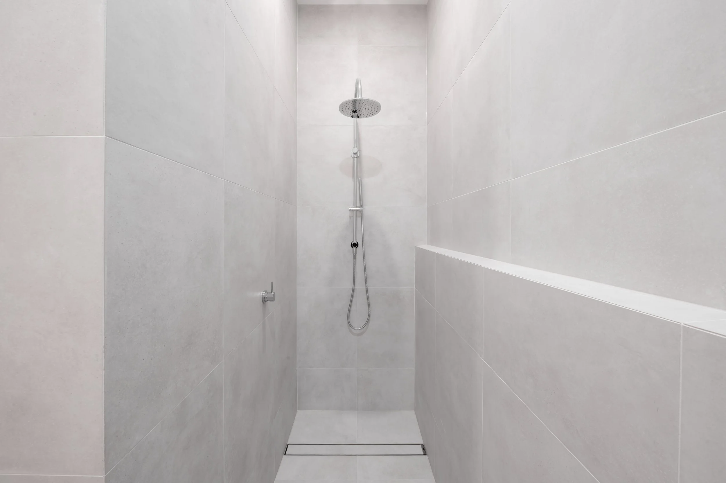 Brighton Project powder room shower with modern fixtures and clean, contemporary finishes.