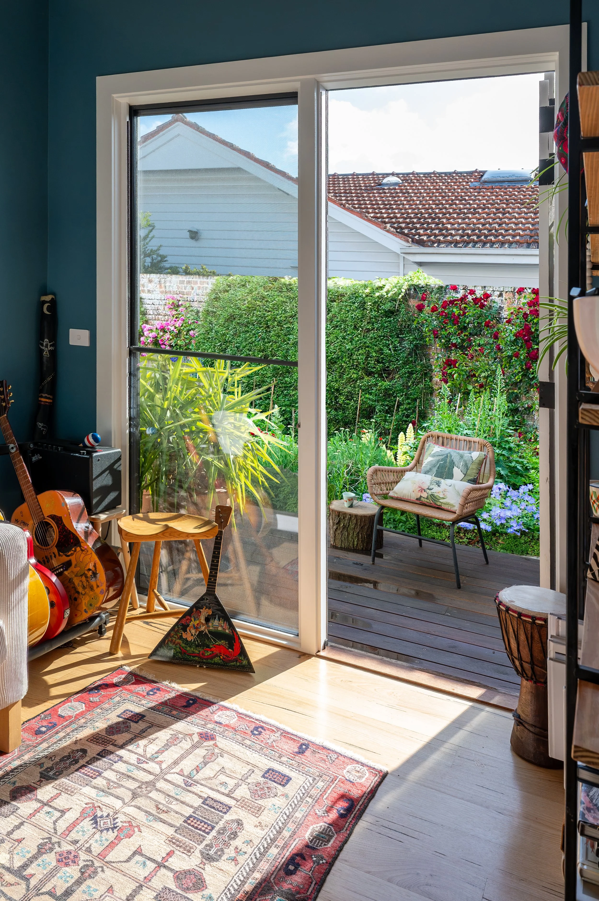 Oak Street Project music lounge opening onto the side of the home, creating a seamless indoor-outdoor living experience.