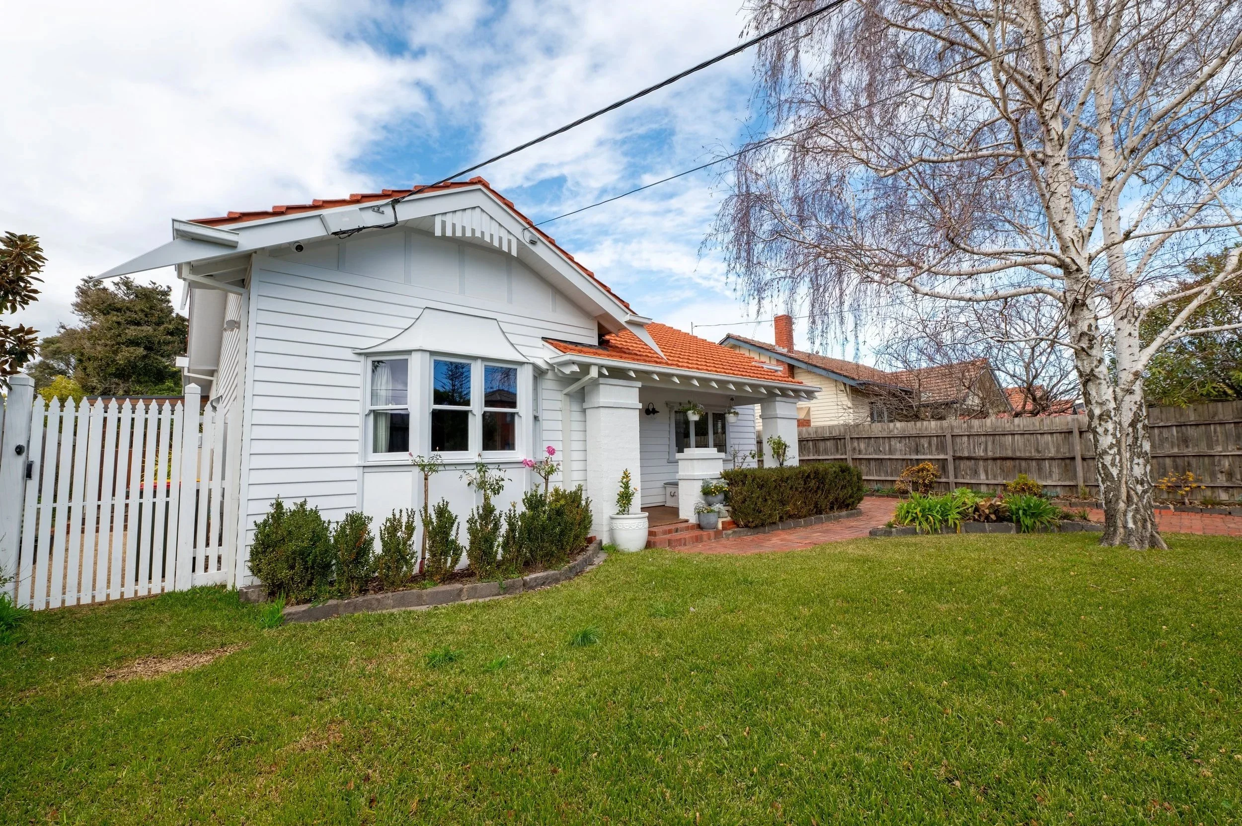 Reimagined exterior facade of the Oak Street Californian bungalow, showing updated finishes, windows, and landscaping