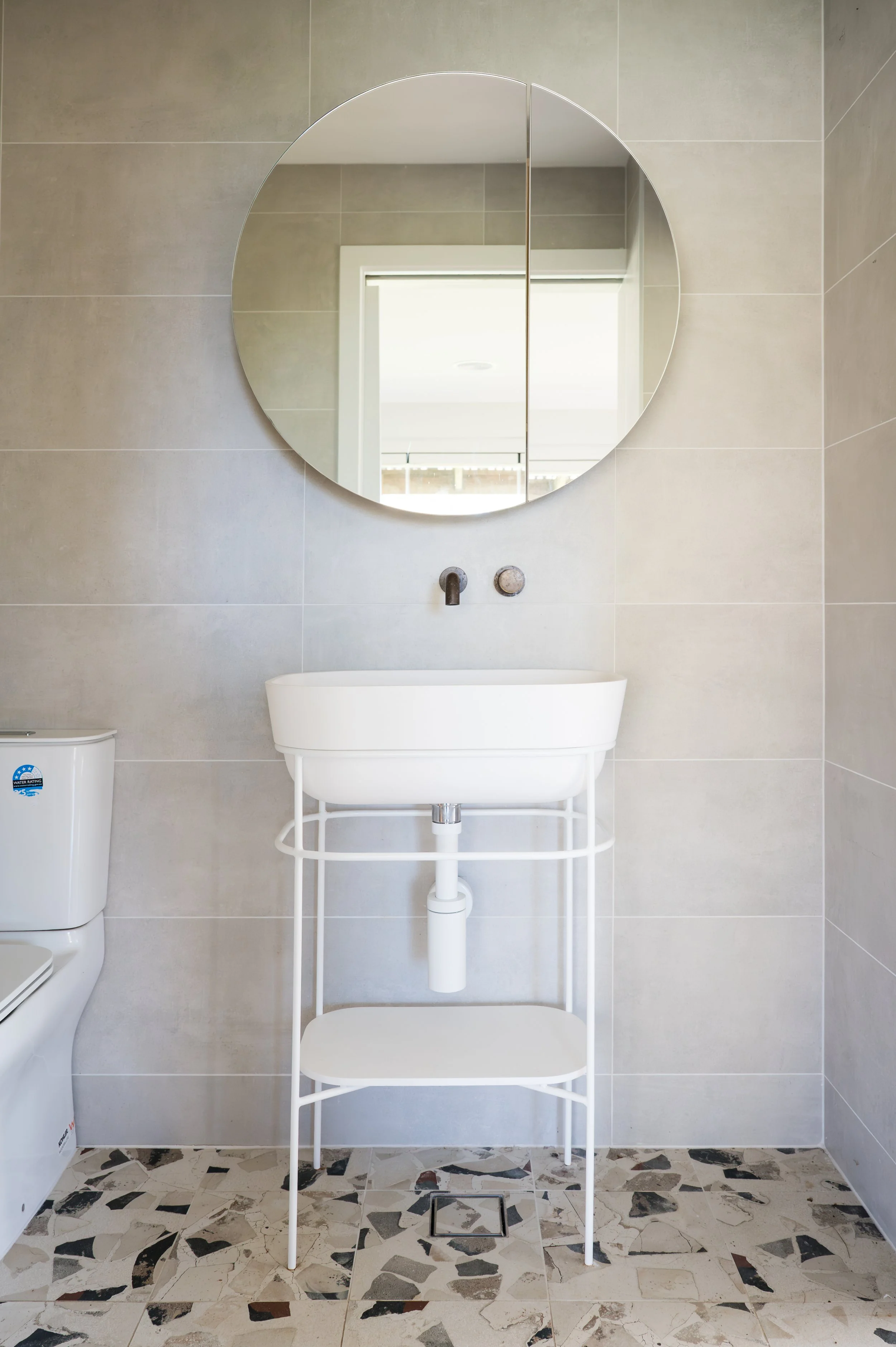 Country Victoria bathroom featuring Brodware fixtures in Organic Living Weathered Brass, a low-maintenance vanity, and wall cabinet mirror