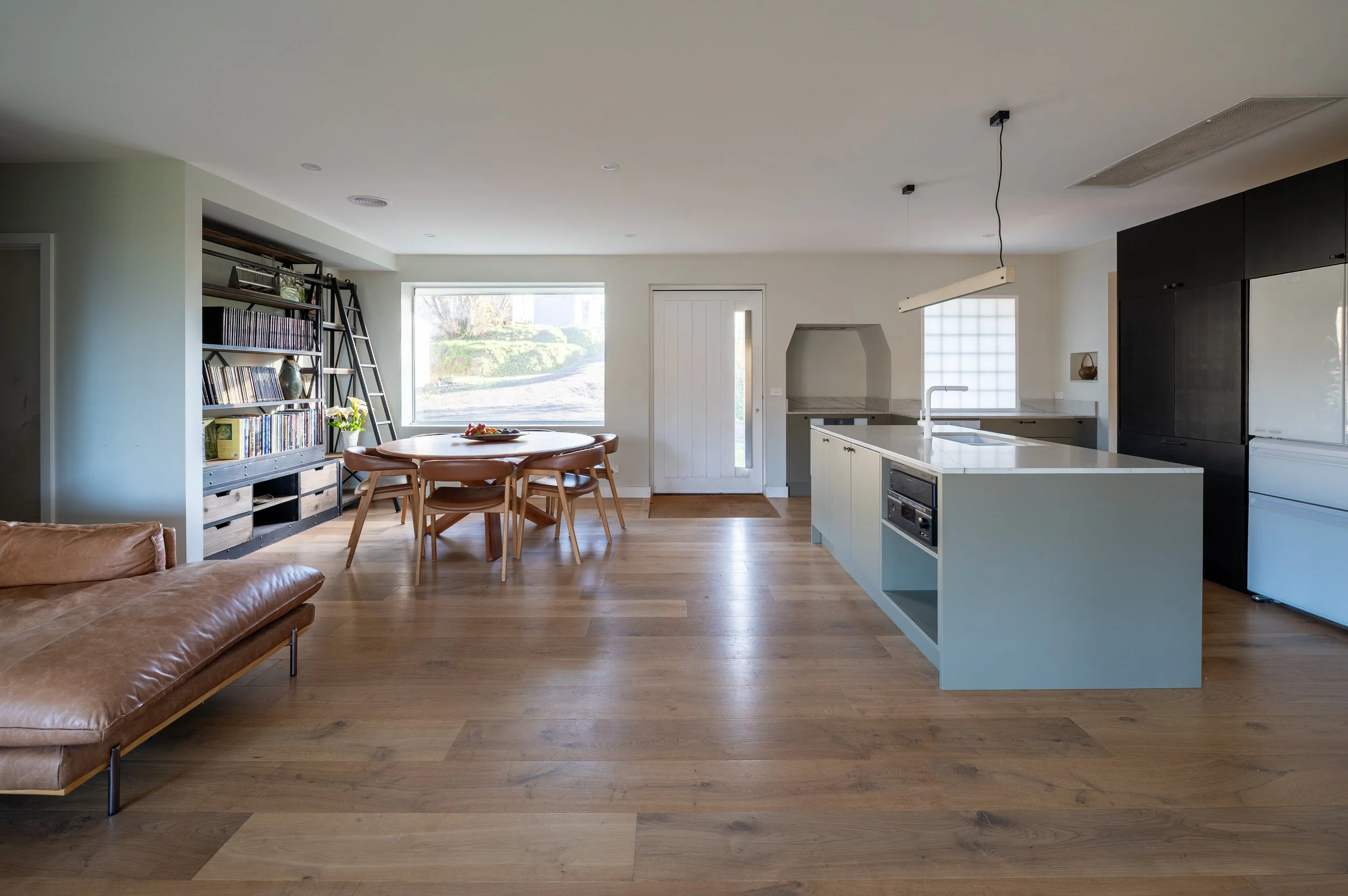 Country Victoria home interior showing the lounge flowing toward the dining entry and kitchen.