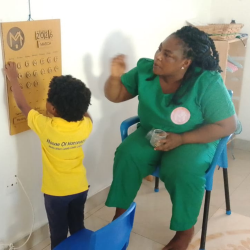 Montessori Directress guiding a child at the calendar board