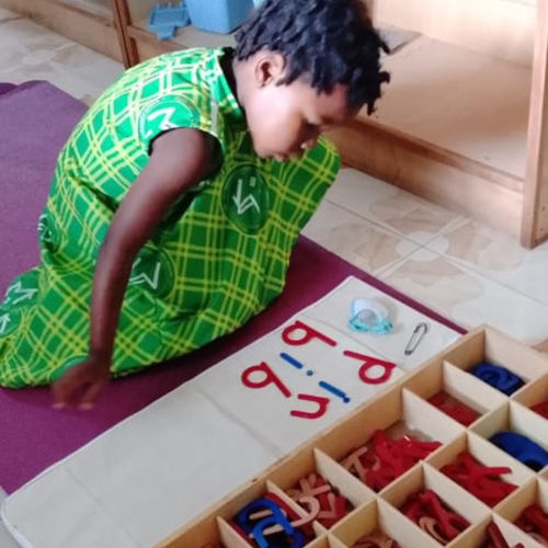 House of Montessori student working independently with Montessori materials