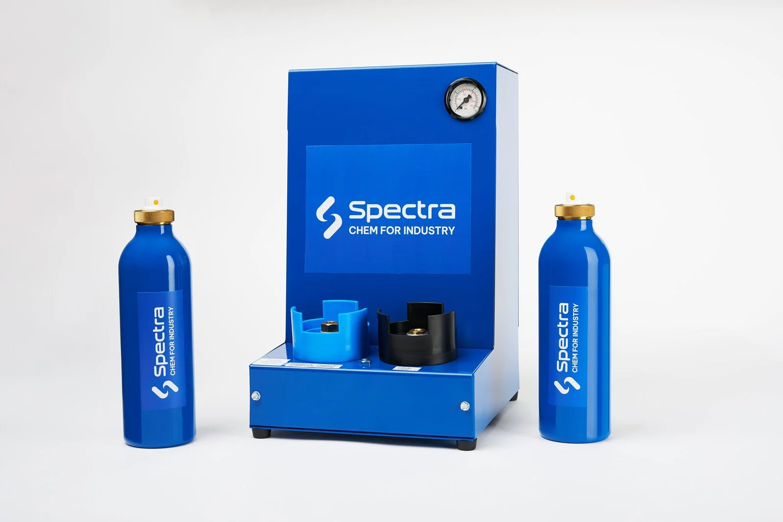 Two blue bottles with gold caps and white straws and a blue and black device with the Spectra logo on it.