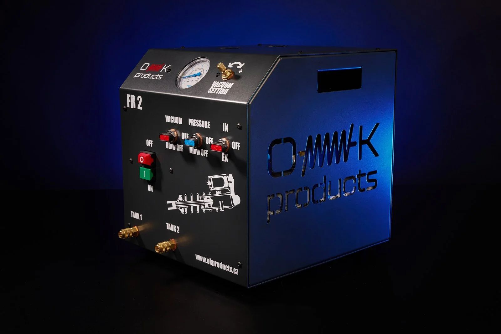 A metal device with dials, switches, and fittings labeled 'OK Products,' featuring pressure gauges and tank connectors, used for vacuum and pressure testing.