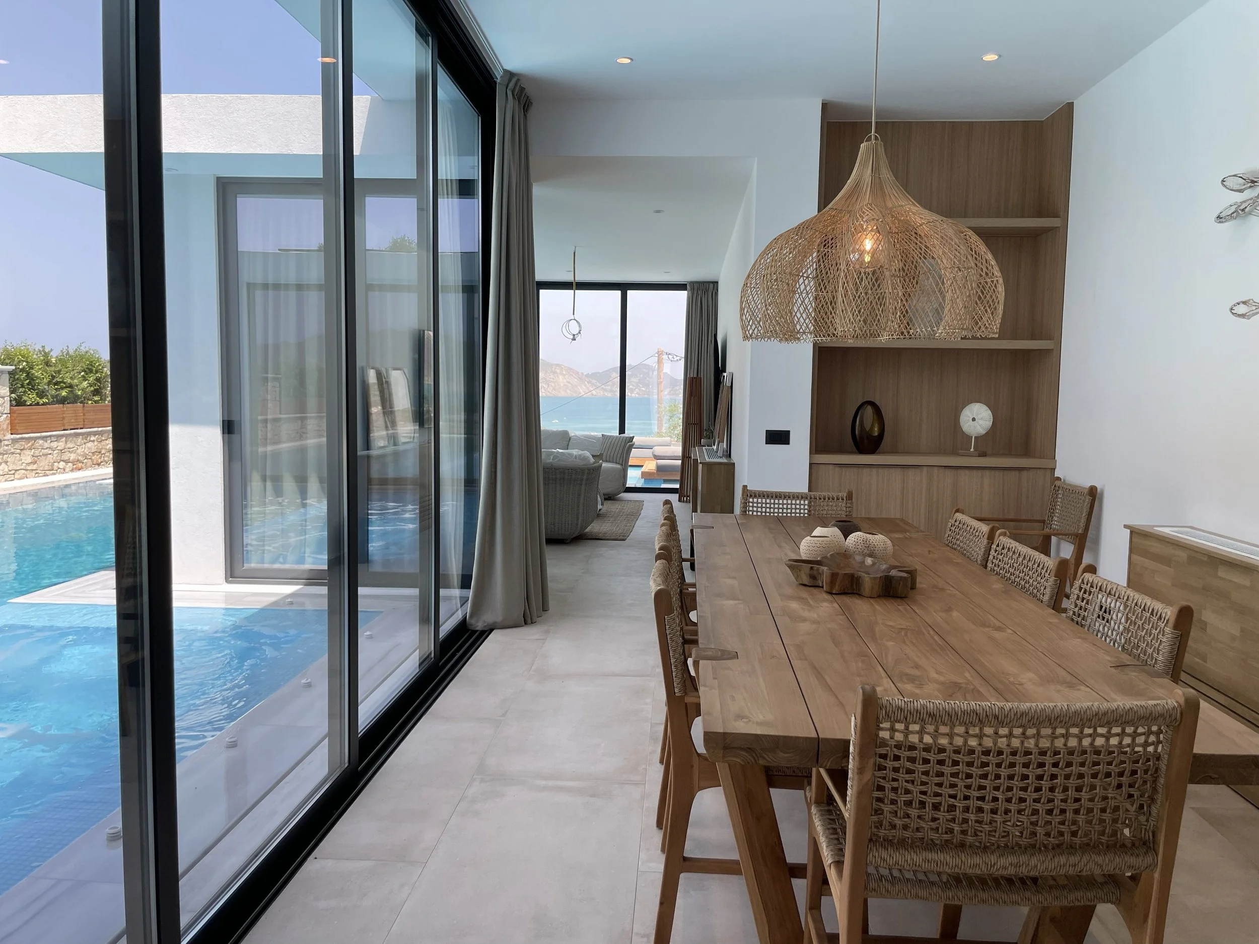 Open-plan dining and living area with sea view and pool in a luxury Zakynthos villa – Levante Villas