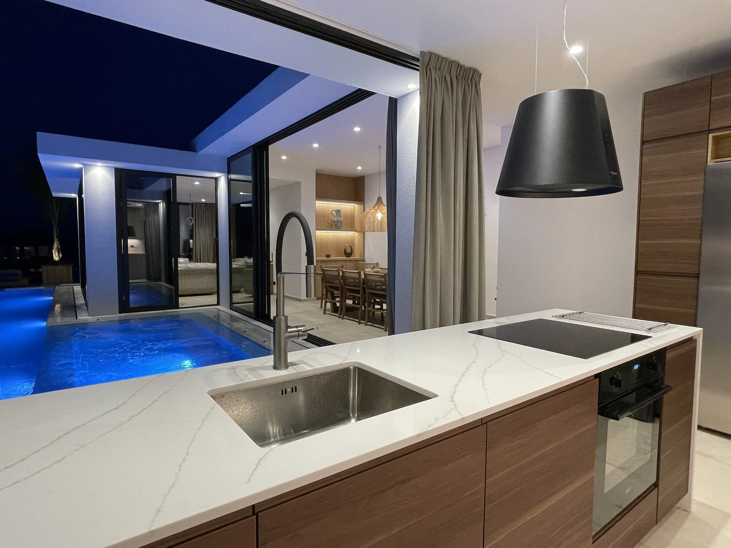Modern kitchen with pool view in a luxury private villa in Zakynthos – Levante Villas