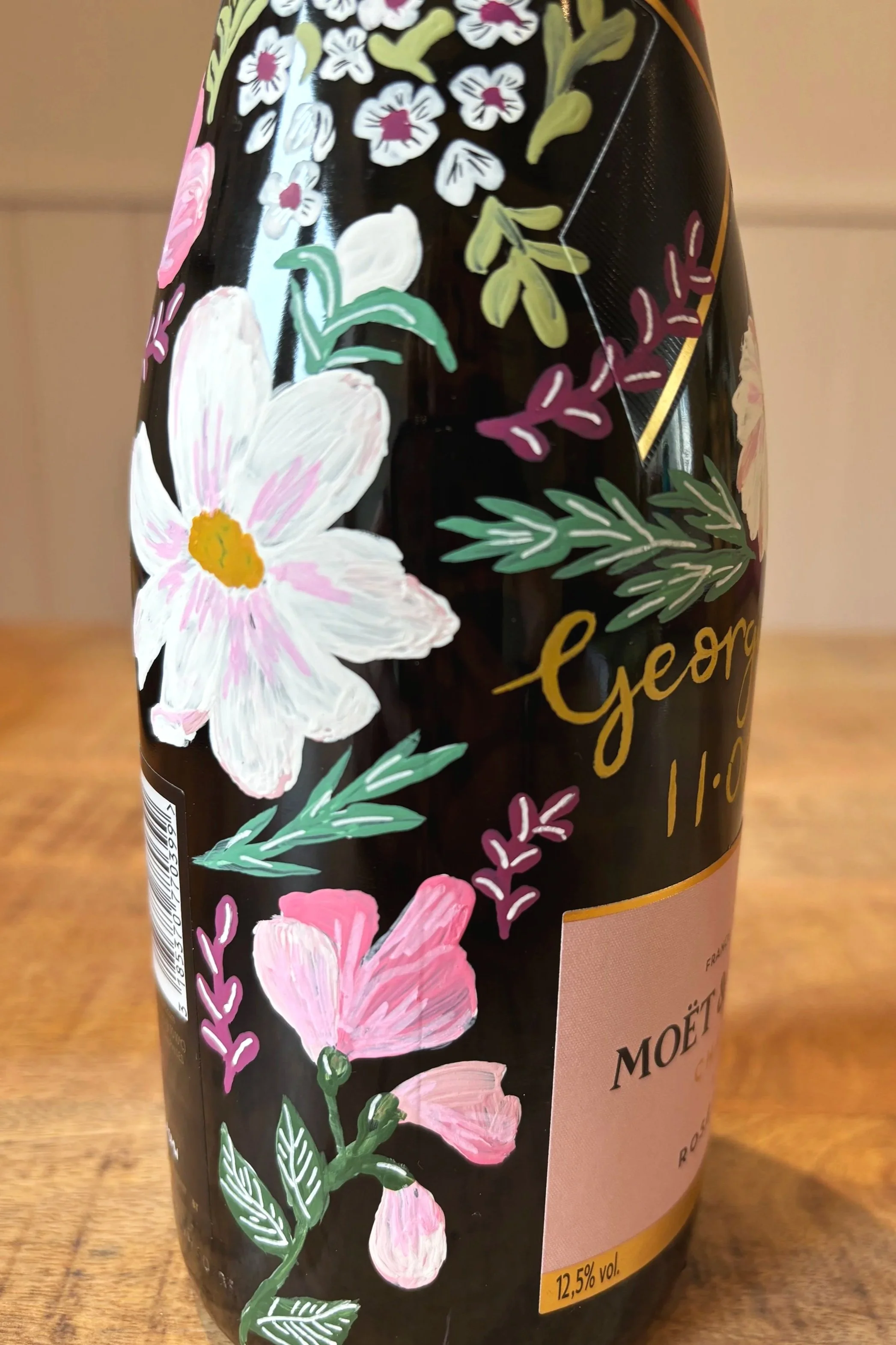 Hand painted champagne bottle of Moet & Chandon using bright floral patterns. By Minutes illustration.