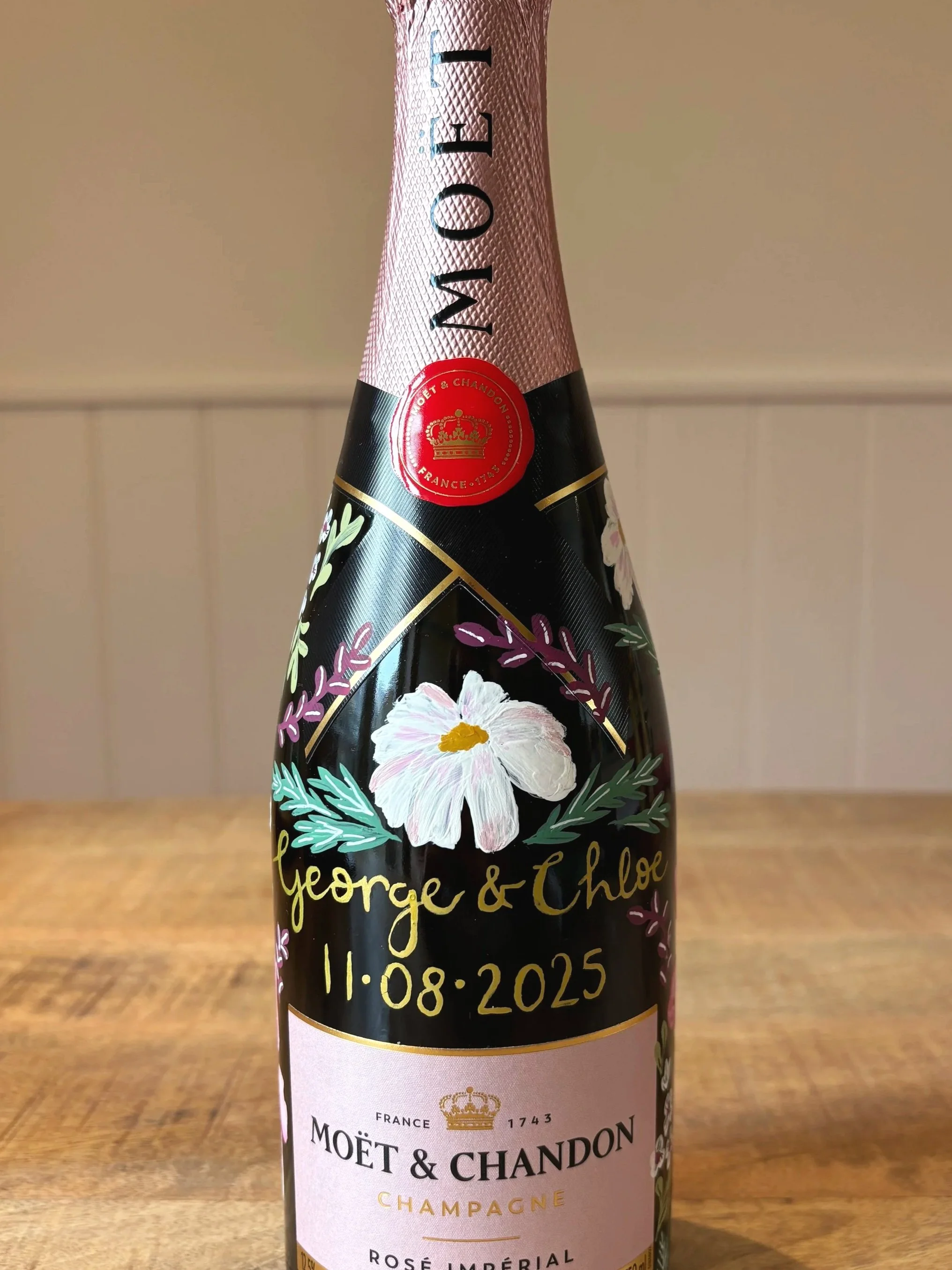 Hand painted champagne bottle of Moet & Chandon using bright floral patterns. By Minutes illustration.