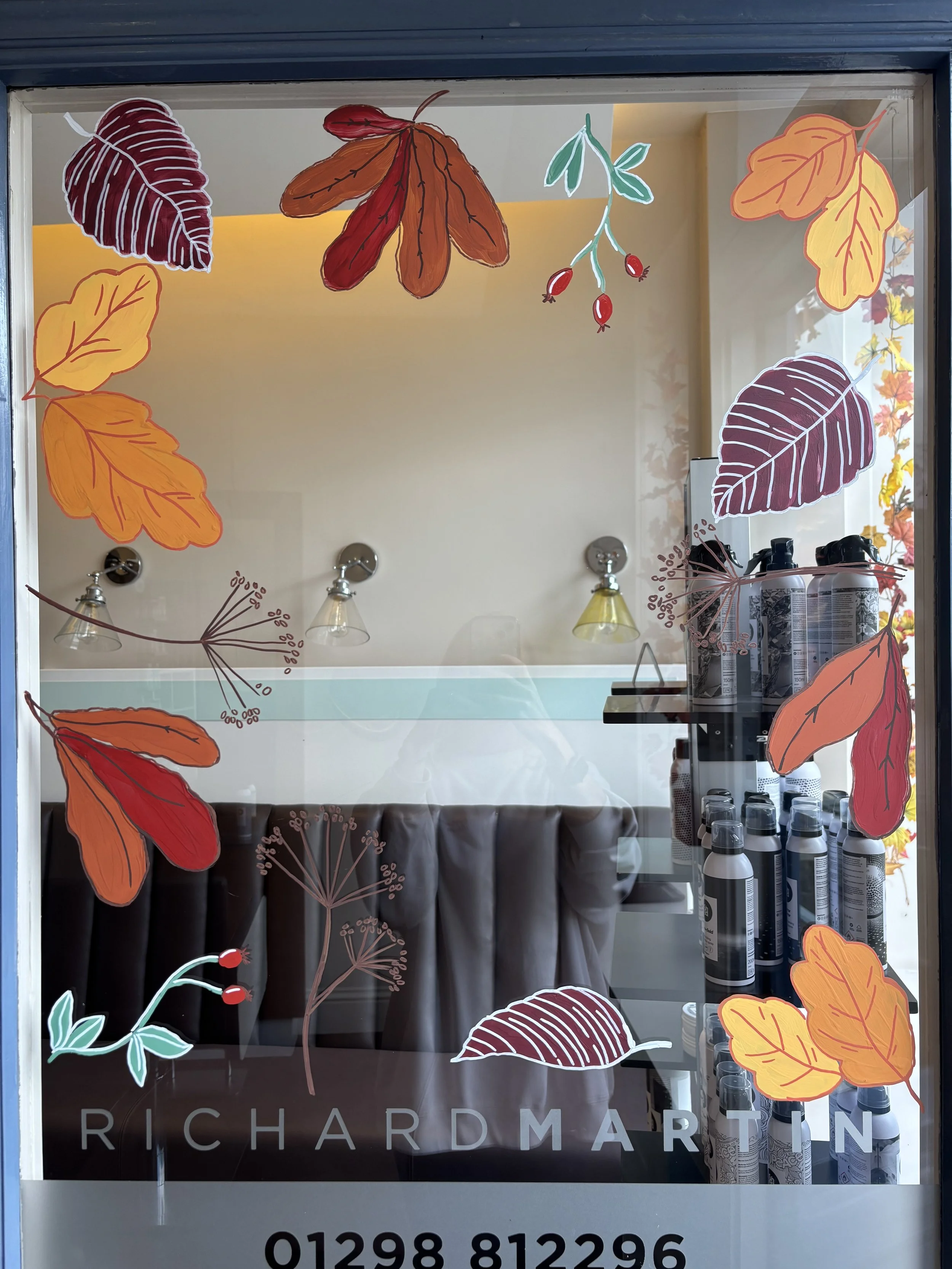 Hand painted autumn window display. Glass painting. Autumn scene with autumn leaves. Hand painted window artist. 