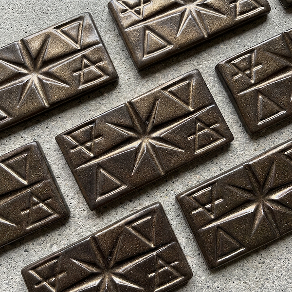 Sample ceramic tile in Hathor glaze, sculptural geometric detail