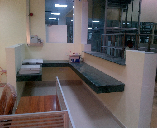 Fit-out works for Grand Central Bakery Qatar with a black countertop, equipment, and a person in the background.