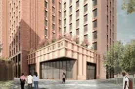 Modern hotel entrance with a group of people walking nearby, tall buildings, and trees along a city street.