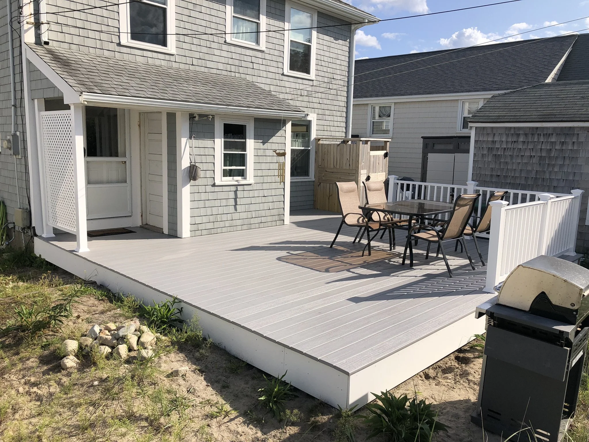 335 S.F. Deck Replacement: This project was a complete replacement of a previous cedar deck, including nine new Diamond Pier DP75 footings and pressure treated framing. Fiberon Paramount solid PVC decking was secured with concealed screws throughout.