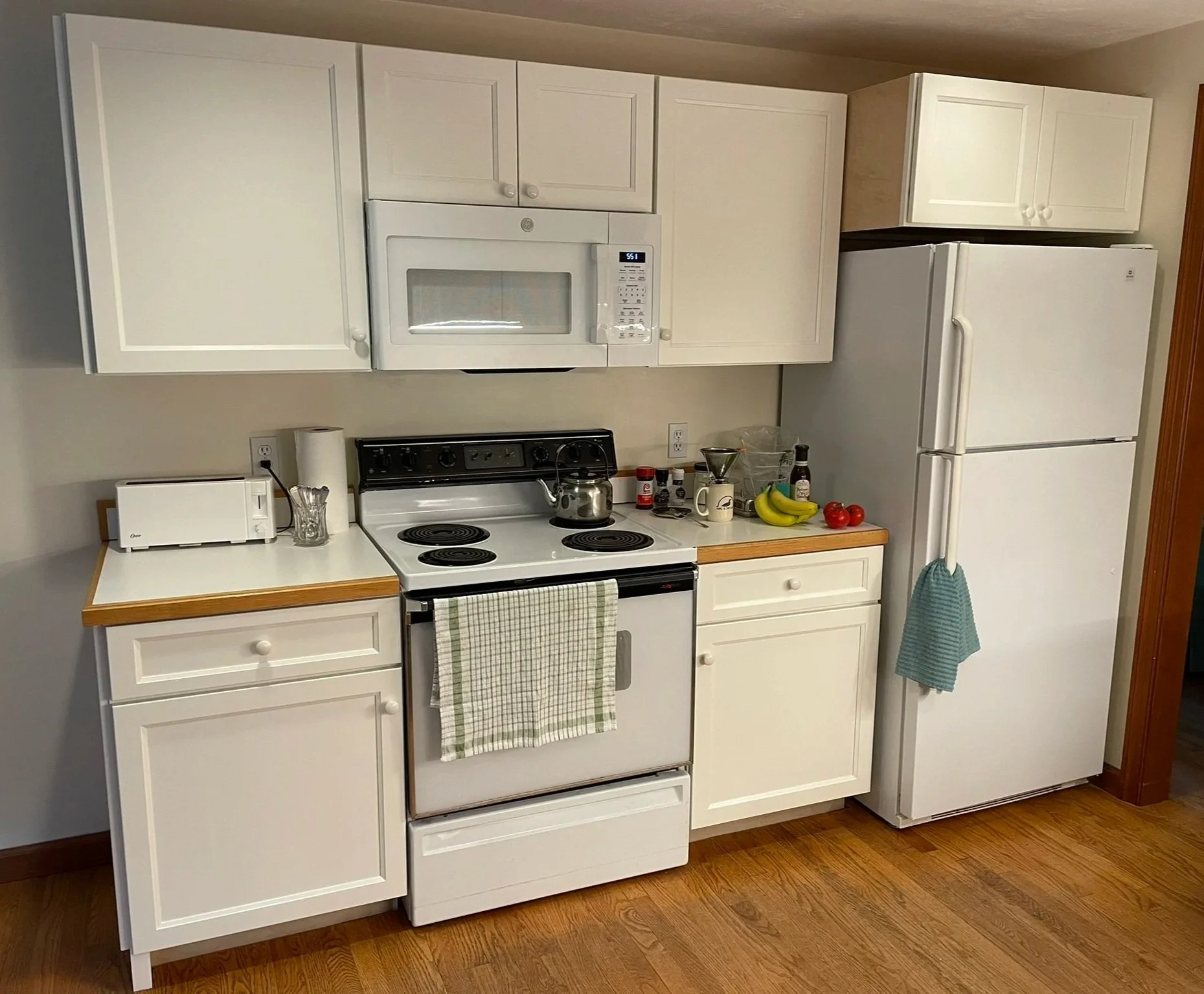 The vinyl-clad, particle board cabinets the homeowner inherited had lived a full life. Peeling vinyl and failed hinges now dominated this otherwise lovely and functional kitchen. New custom hardwood cabinets from Norfolk Kitchen and Bath were purchas