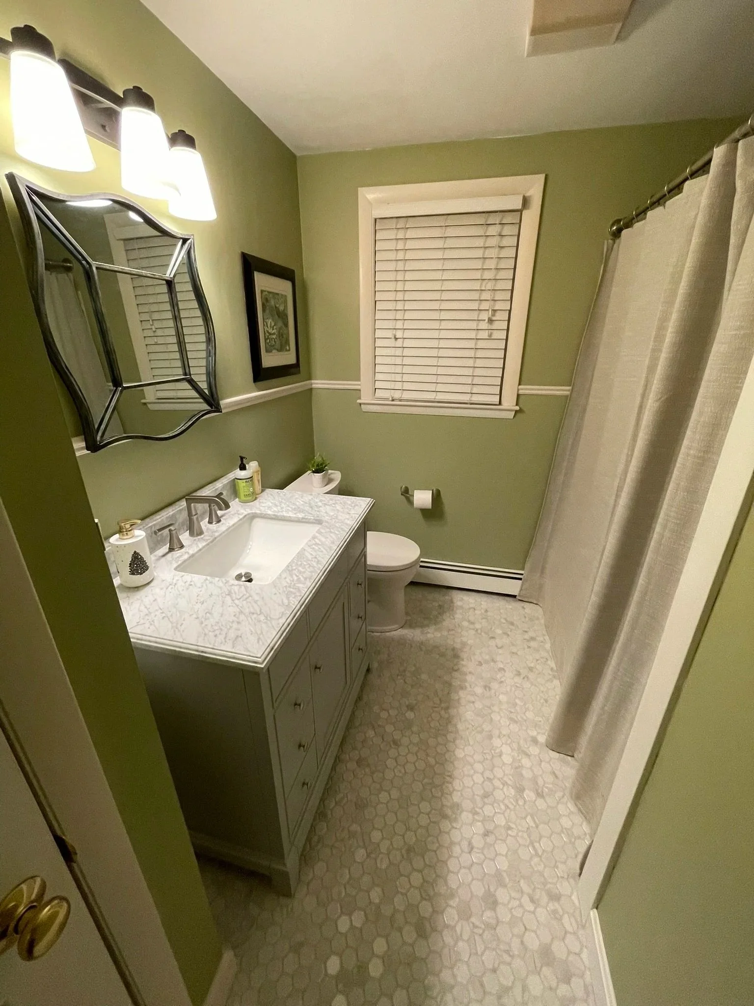 This circa early-60's bathroom has served its time. The half-height tile walls had been painted over, peeled and repainted, the tile floor was no longer attractive, and the vanity and sink were in disrepair. 

Once a new hardwood vanity and marble va