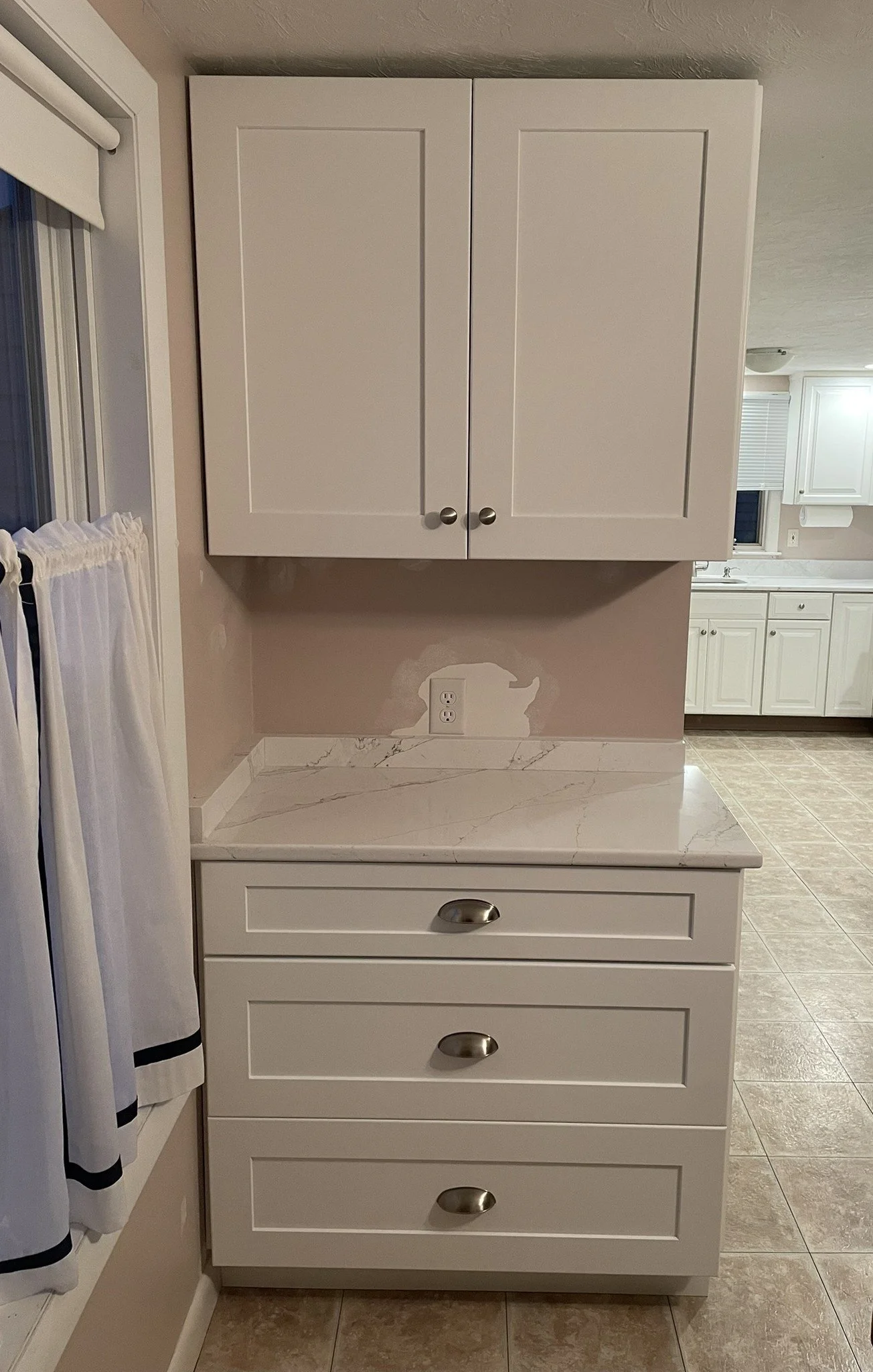 Matching upper and lower cabinets, also from NKB, were added in the corner of the dining area to replace a small freestanding drawer unit.