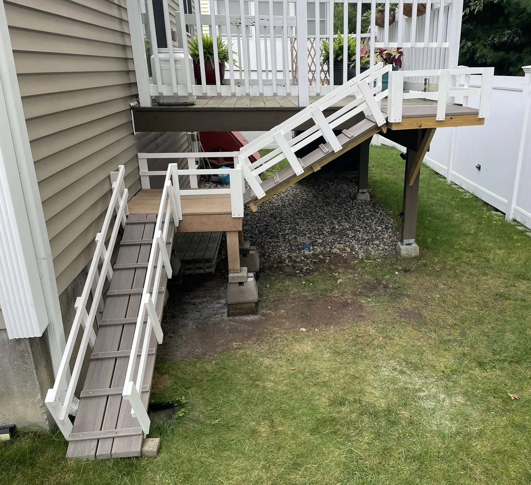 Doggy Deck Ramp: Steps were posing a challenge for the homeowner's beloved dog, so we designed and built a custom dog ramp from the deck to the enclosed yard. After a few treats for training, Remy was once again fully independent. And with Trex Trans