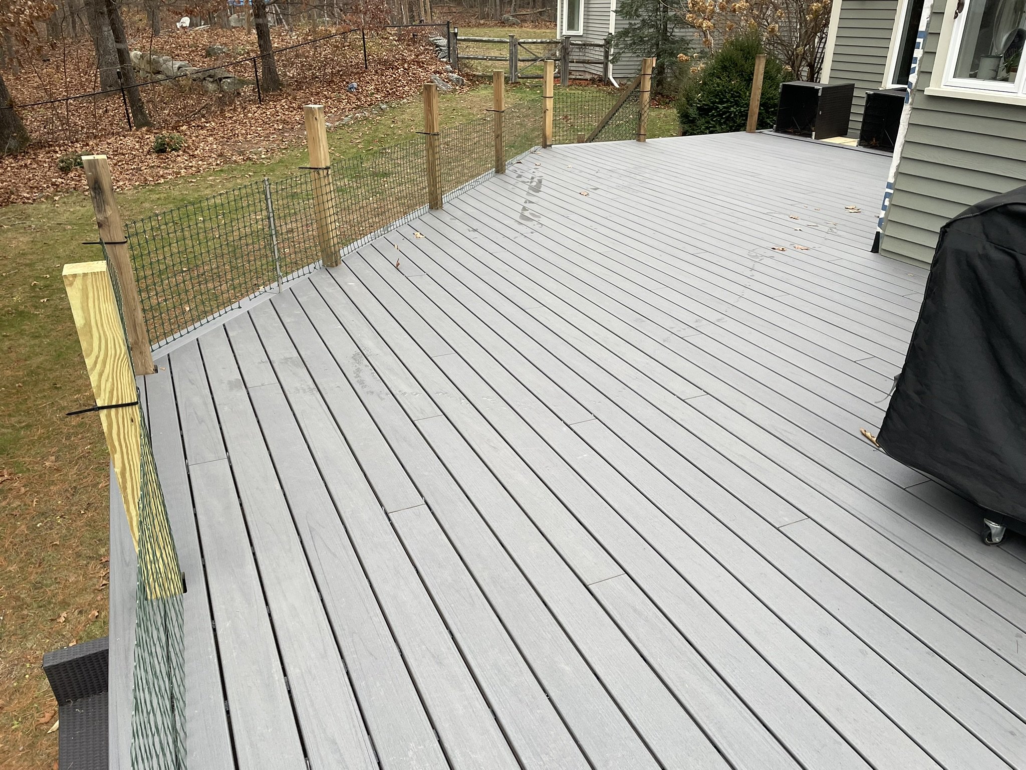 1,000 S.F. Deck Refresh: This project involved the replacement of a large wood deck and wood railings overlooking an expansive yard and woodlands. Trex Transend Lineage decking was installed throughout, beginning with "picture framing" the deck using