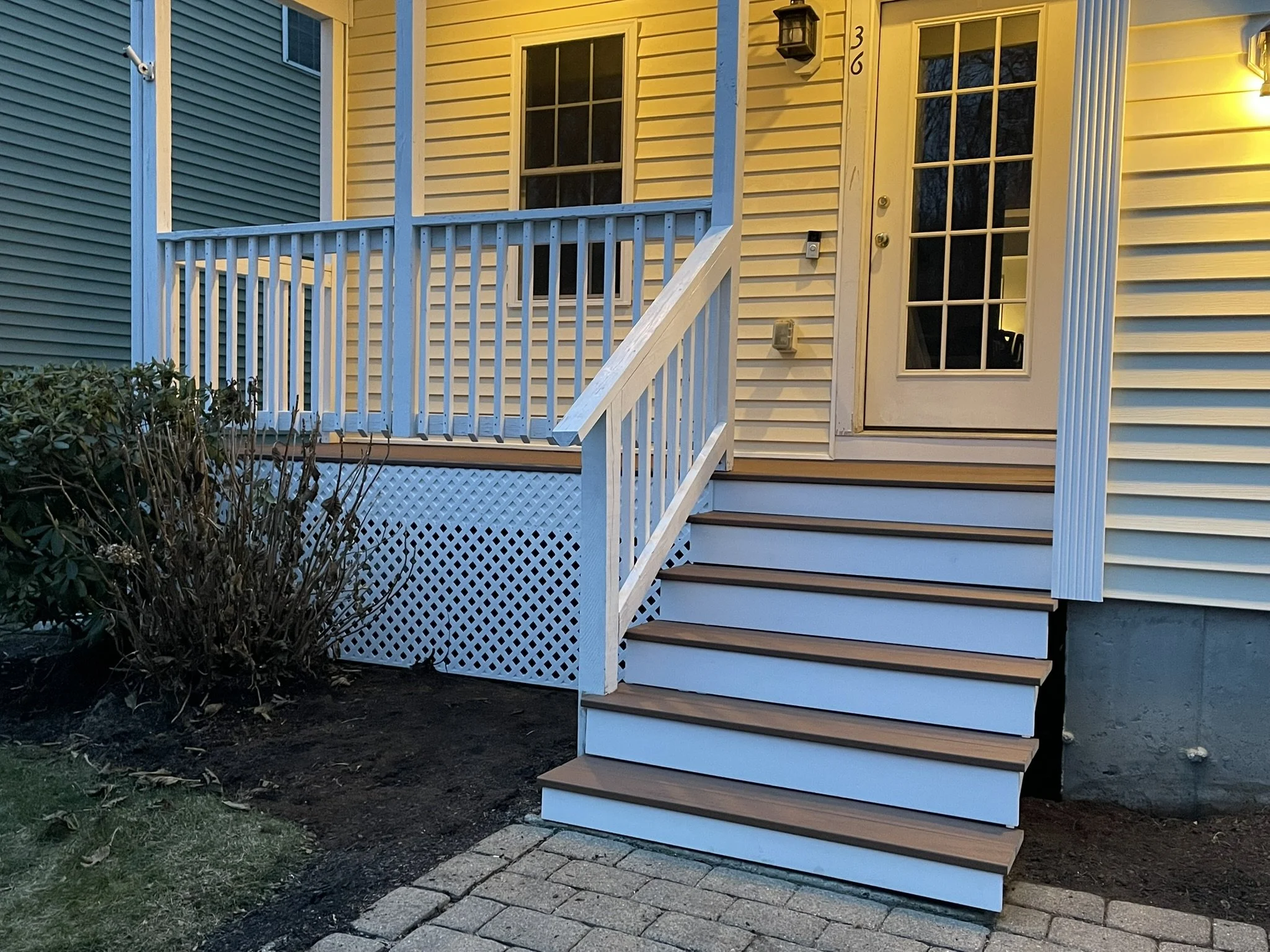 Decking Replacement & Added Trimwork: Builder-grade pressure treated decking and stairs were replaced with Trex Transcend Lineage decking and PVC risers, using concealed screws throughout. PVC fascia and privacy lattice were added to provide a fully 