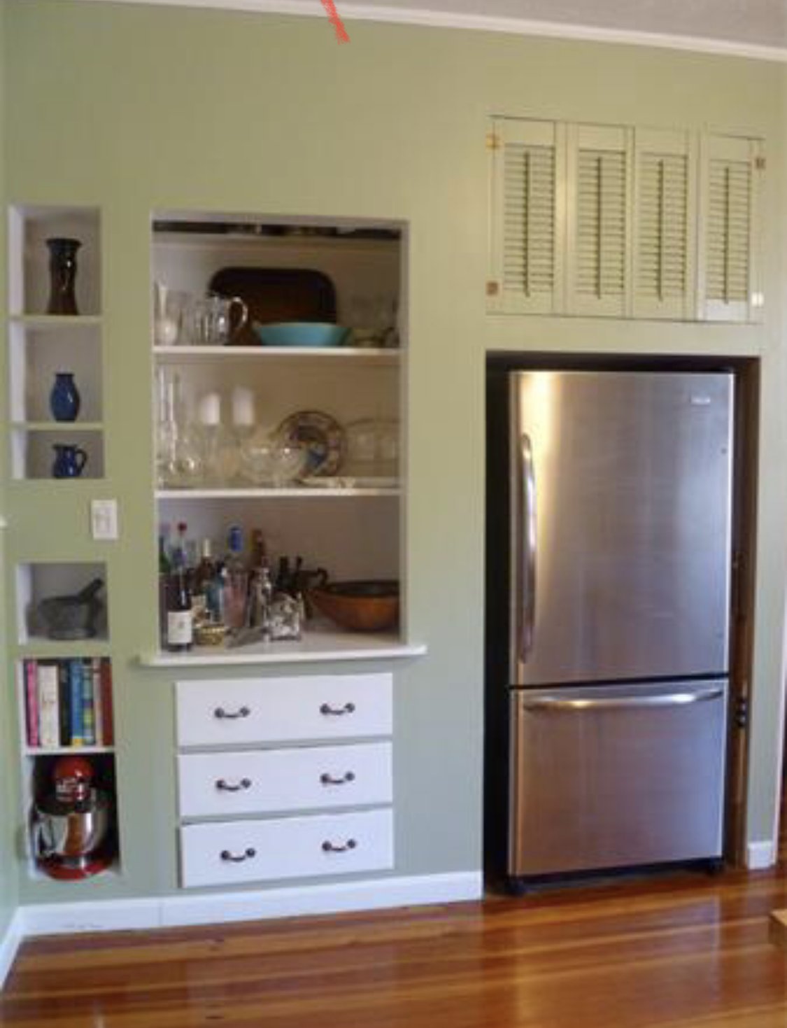 1900's Pantry: To increase the available closet space behind the wall shown in this circa 1900 brownstone, a step-in pantry cabinet was pulled forward to be flush with the kitchen wall. Built-in cubbies were added on the left and the wall on the righ