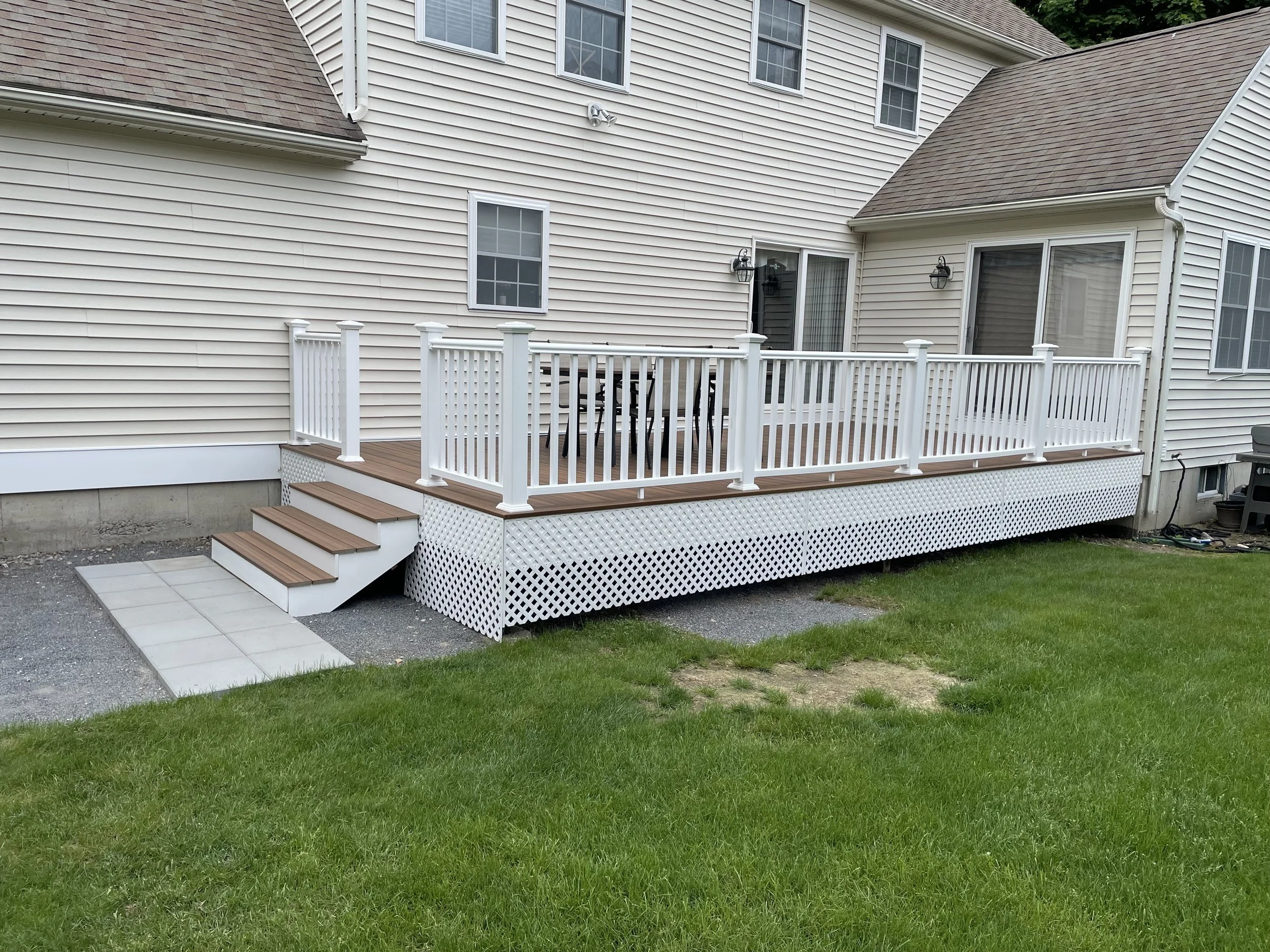 300 S.F. Deck Replacement: The original wood deck, railings and trim overlooking this large, sunny and private back yard had degraded to the print that there were valid safety concerns, not to mention the obviously aesthetic impact. After cutting bac