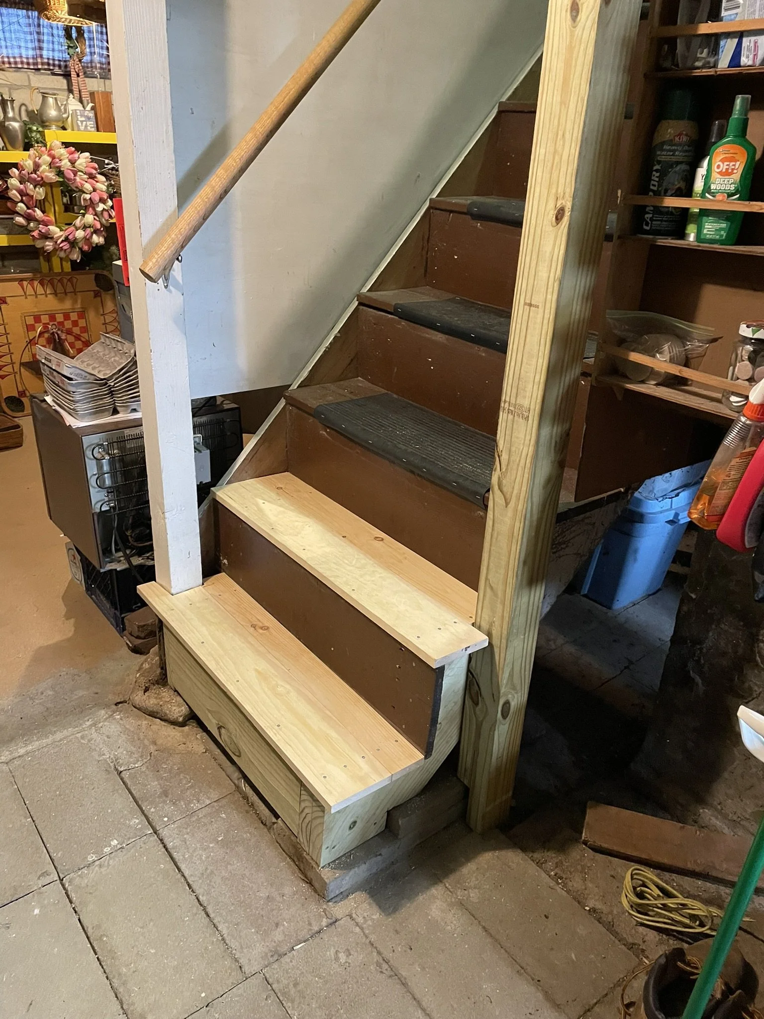 Adding a second handrail to the basement stairs in this Metrowest antique required first shoring up the badly eroded staircase itself. Once that was done, a new post was added to the support the new railing, which had been stained to match the hand-w