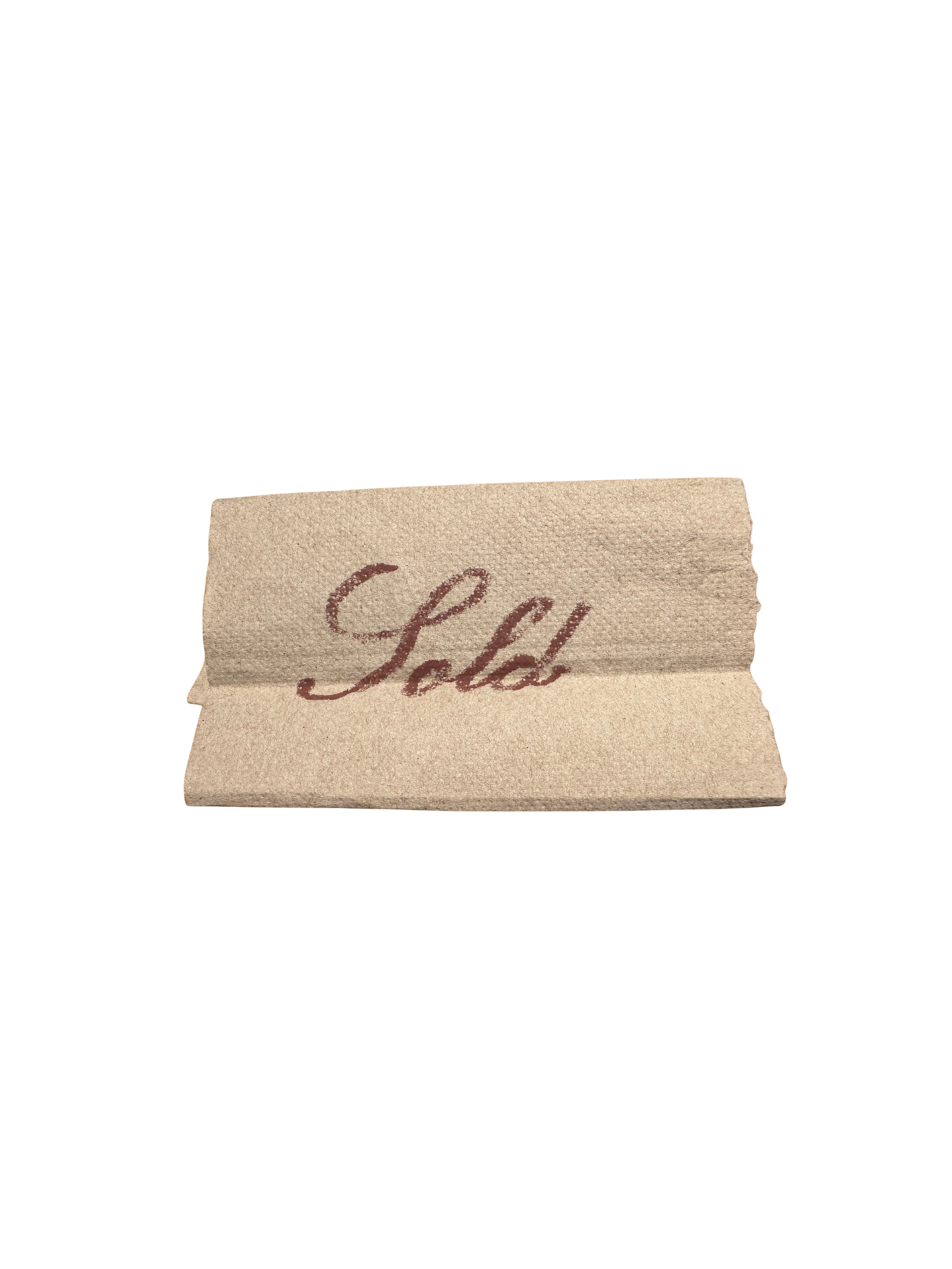 Close-up of a torn piece of paper with the word "Love" written in cursive.