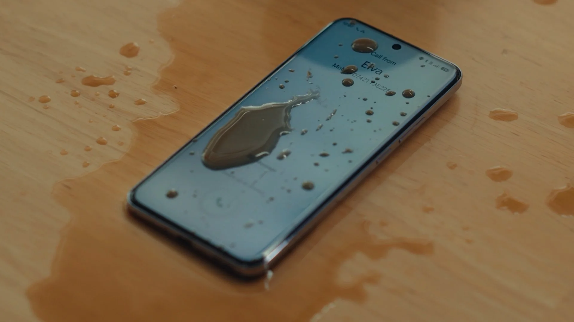 A close up of the OPPO Omega phone with coffee on top