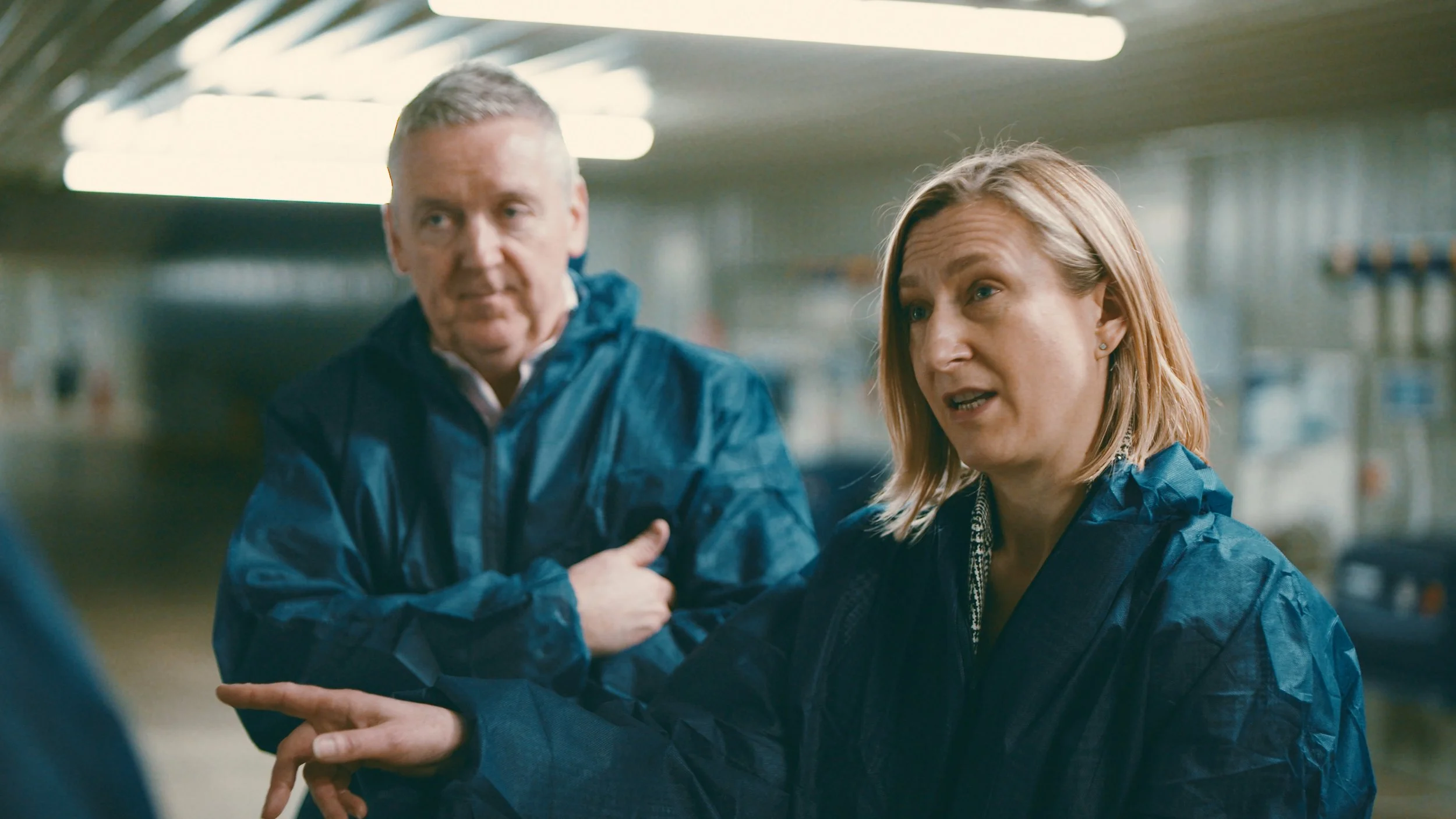 Two workers discuss a point in the factory